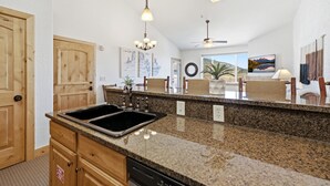 A kitchen with granite countertops, wooden cabinets, a double sink, and pendant lighting. - New Listing Canyons Resort, Silverado, Pool, Golf! (Park City)