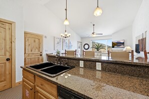 A kitchen with granite countertops, wooden cabinets, a double sink, and pendant lighting. - New Listing Canyons Resort, Silverado, Pool, Golf! (Park City)