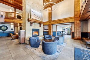 A spacious lobby with a stone fireplace, seating area, and a view of the upper level. - New Listing Canyons Resort, Silverado, Pool, Golf! (Park City)