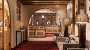 A hotel lobby with a reception desk, a red carpeted area, and a seating arrangement. - 1 Person Holiday Park Home in Garmisch-partenkirchen (Garmisch-Partenkirchen)