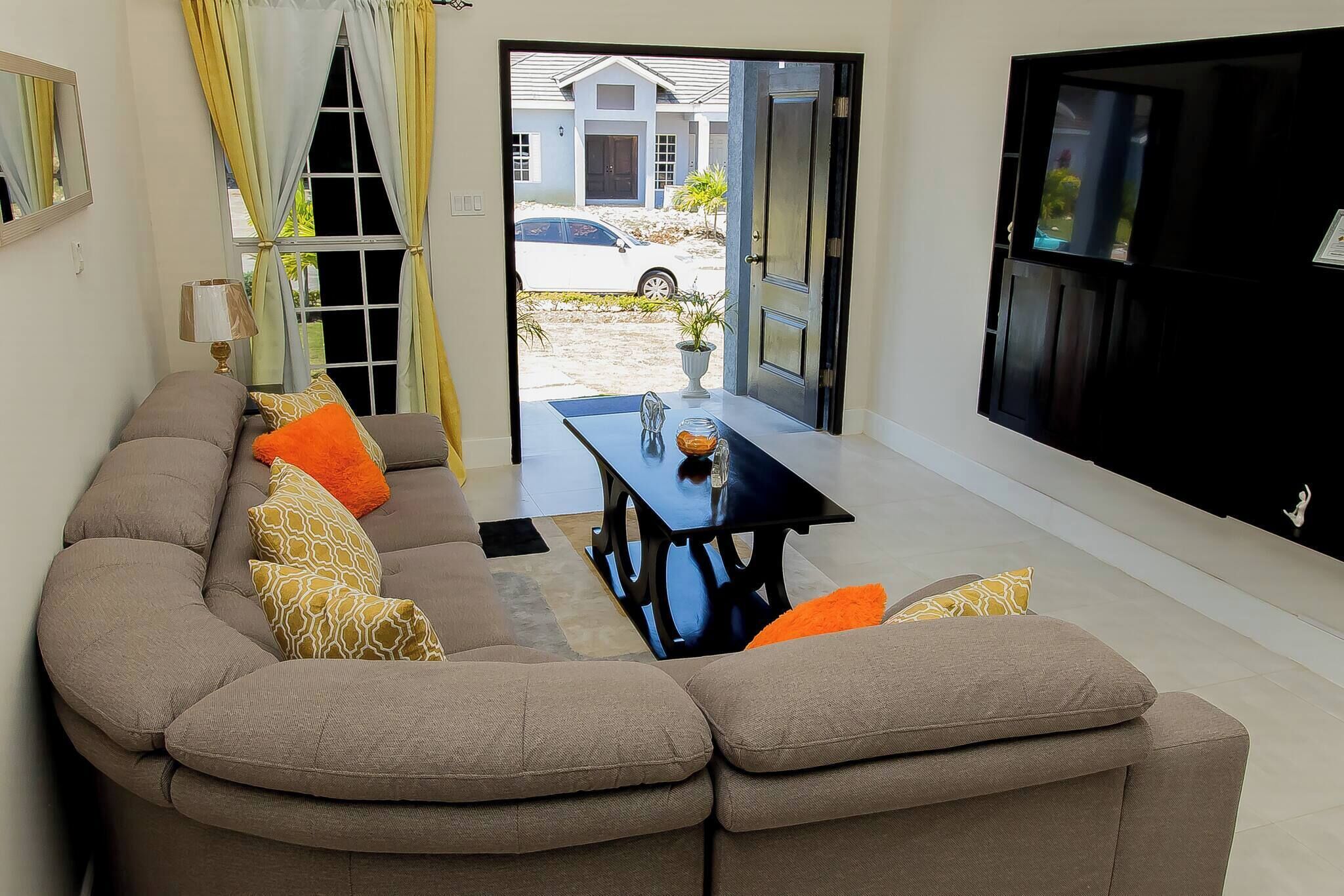 A living room with a sofa, a table, and a TV.