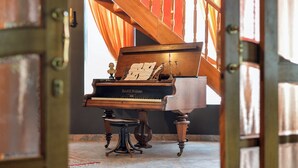 A grand piano in a room with a staircase and a large window. - Requiem Rustical Heaven Villa With Outdoor Pool (Bednja)