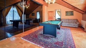 A pool table in a room with wooden floors and a sloped ceiling. - Requiem Rustical Heaven Villa With Outdoor Pool (Bednja)