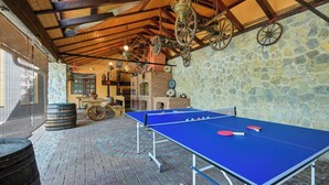 An indoor ping pong table with a stone wall and wooden beams. - Requiem Rustical Heaven Villa With Outdoor Pool (Bednja)