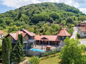 Zona residencial con casas, piscina y montañas al fondo.