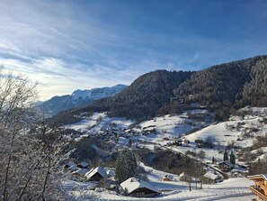A snow-covered village with houses and a mountain backdrop. - The BMC - Mountain Apartment for 4 People (Le Bouchet-Mont-Charvin)