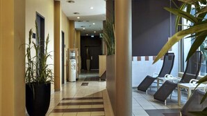 A hotel lobby with a check-in counter, seating area, and a water dispenser. - 4 Person Holiday Park Home in Kassel (Kassel)