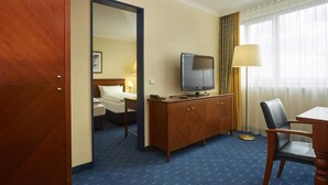 A hotel room with a bed, a television, a desk, and a chair. - 4 Person Holiday Park Home in Kassel (Kassel)