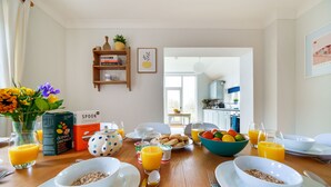 A breakfast table with cereal, juice, and fruit. - Byre House (Sleeps 4) - Sutton Waldron , Shaftesbury sleeps 4 guests  in 2 bedrooms (Blandford)