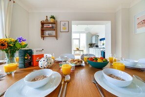A breakfast table with cereal, juice, and fruit. - Byre House (Sleeps 4) - Sutton Waldron , Shaftesbury sleeps 4 guests  in 2 bedrooms (Blandford)