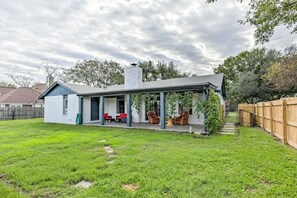 A single-story house with a covered patio area, a small attached garage, and a fenced backyard. - Pet-Friendly Lockhart Home With Private Yard! (Lockhart)