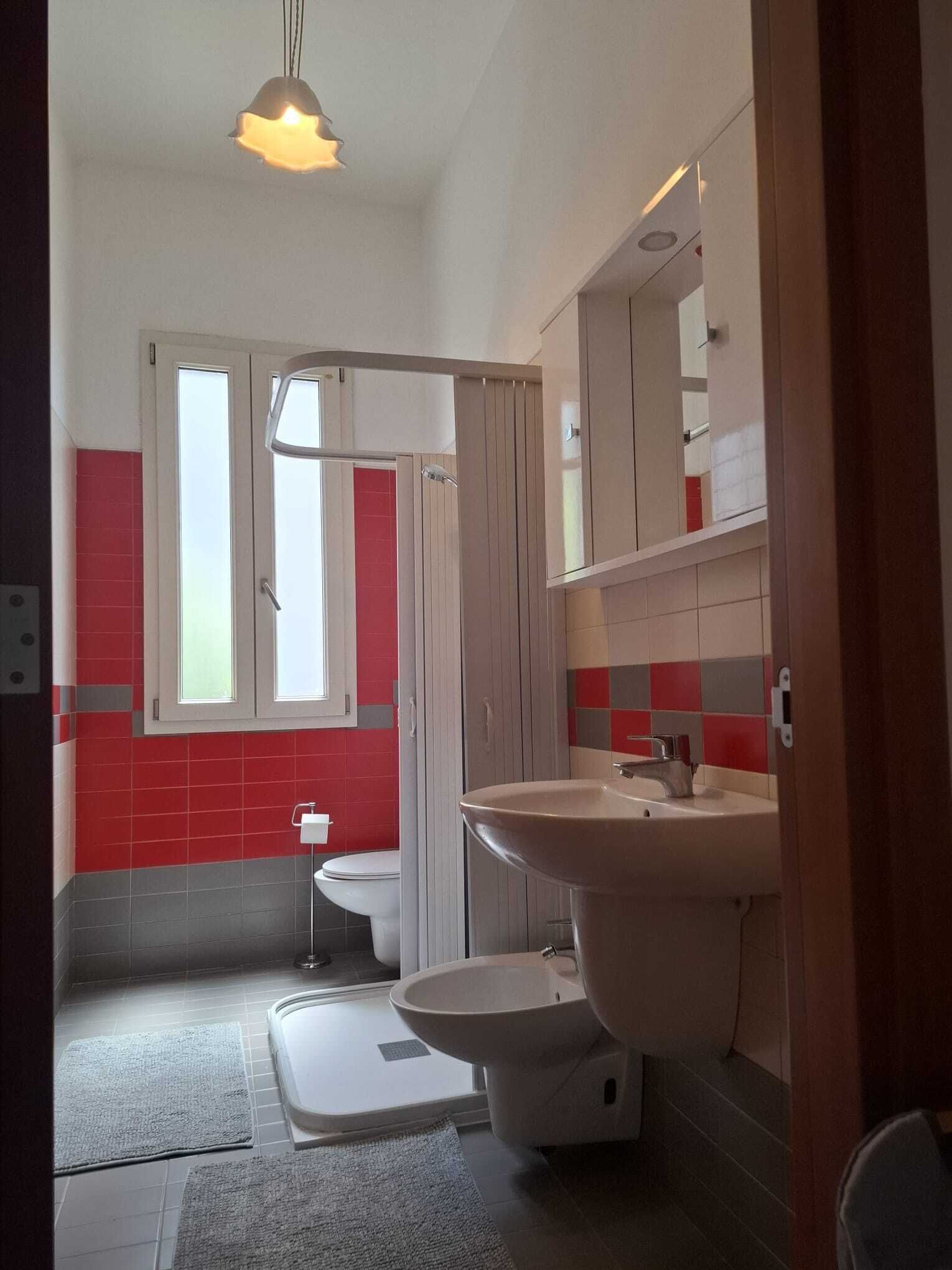 Une salle de bain comprenant des toilettes, un lavabo et un espace douche.