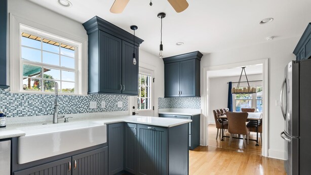 A kitchen with dark cabinets, a white countertop, and a tiled backsplash. - Blackbeard's Isle -  9 beds, 6BR/3BA - 500 ft from Beach (Isle of Palms)