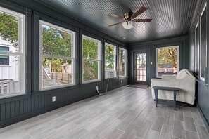 A room with large windows, a ceiling fan, and a bench. - Blackbeard's Isle -  9 beds, 6BR/3BA - 500 ft from Beach (Isle of Palms)