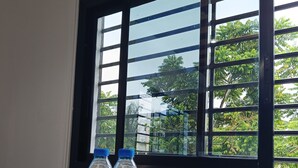 A table with water bottles, jars with wooden lids, and a plate with snacks.