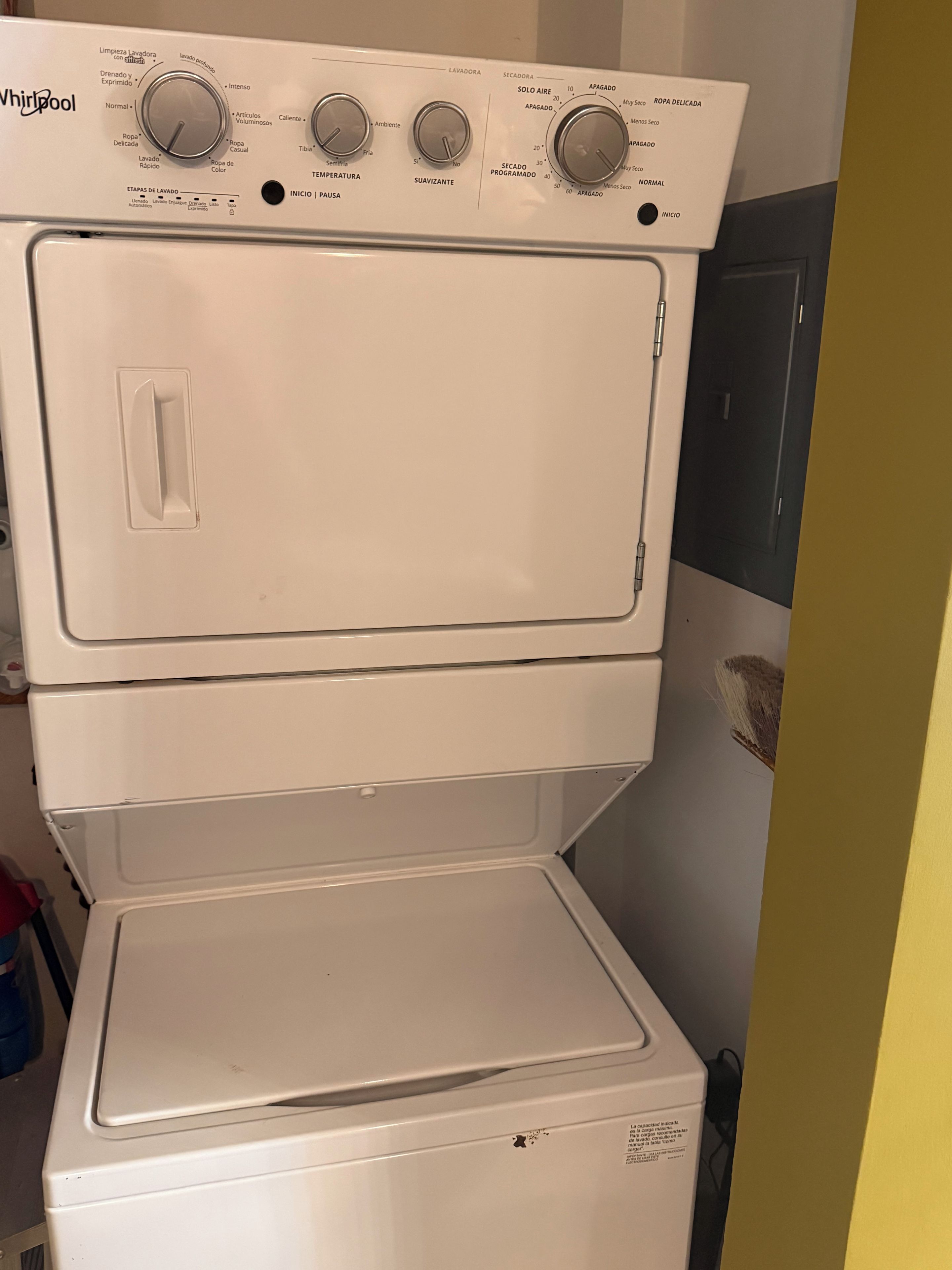 A Whirlpool washer with multiple control knobs and a front-loading door.