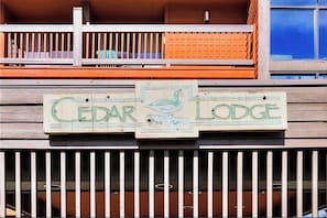 A wooden sign with the text 'CEDAR LODGE' and a bird illustration. - Perfect Frisco Location: Cozy Studio Steps from Main Street (Frisco)