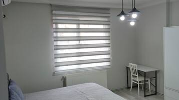 Desk, laptop workspace, blackout curtains, iron/ironing board