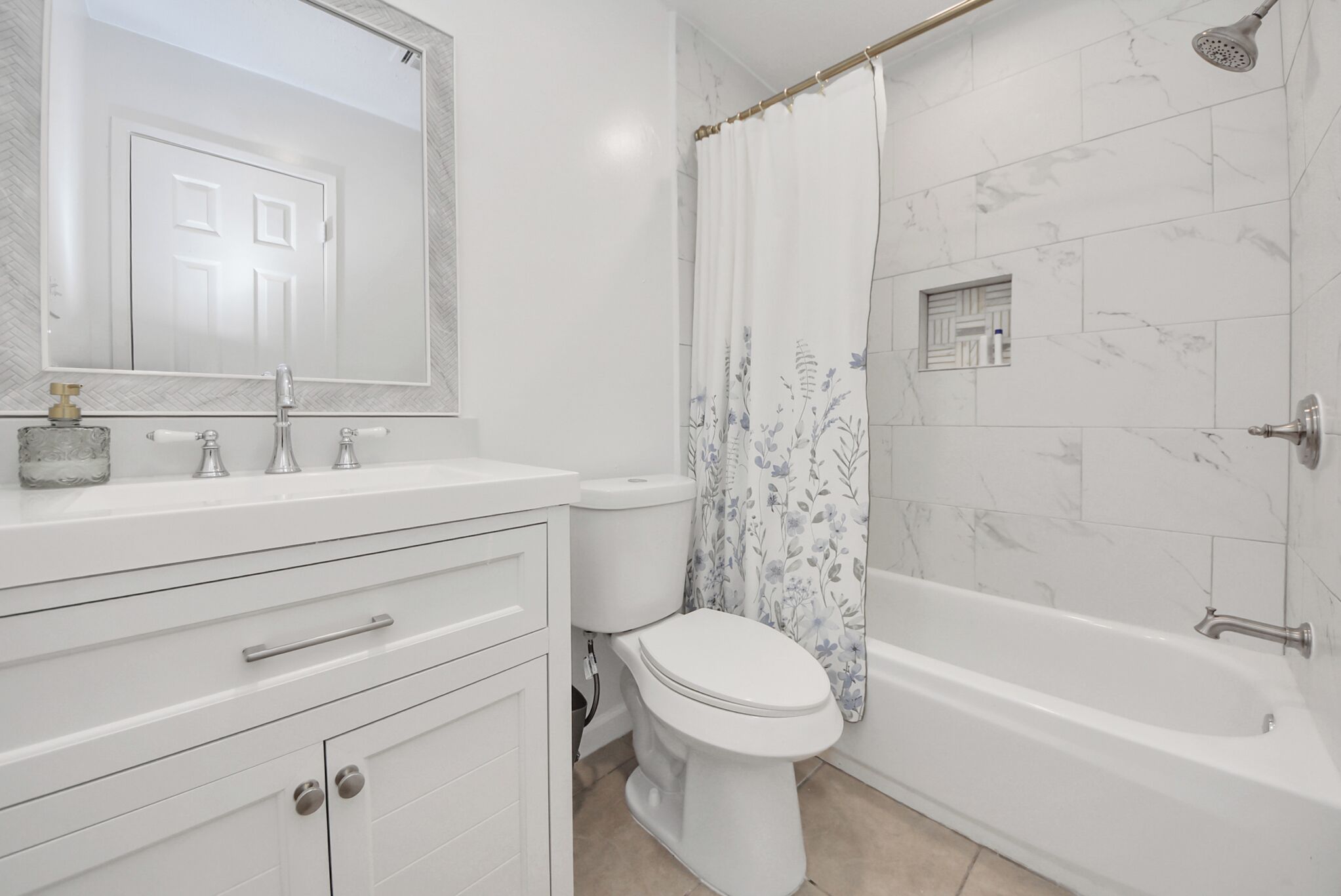 A bathroom with a toilet, sink, mirror, shower, and bathtub.