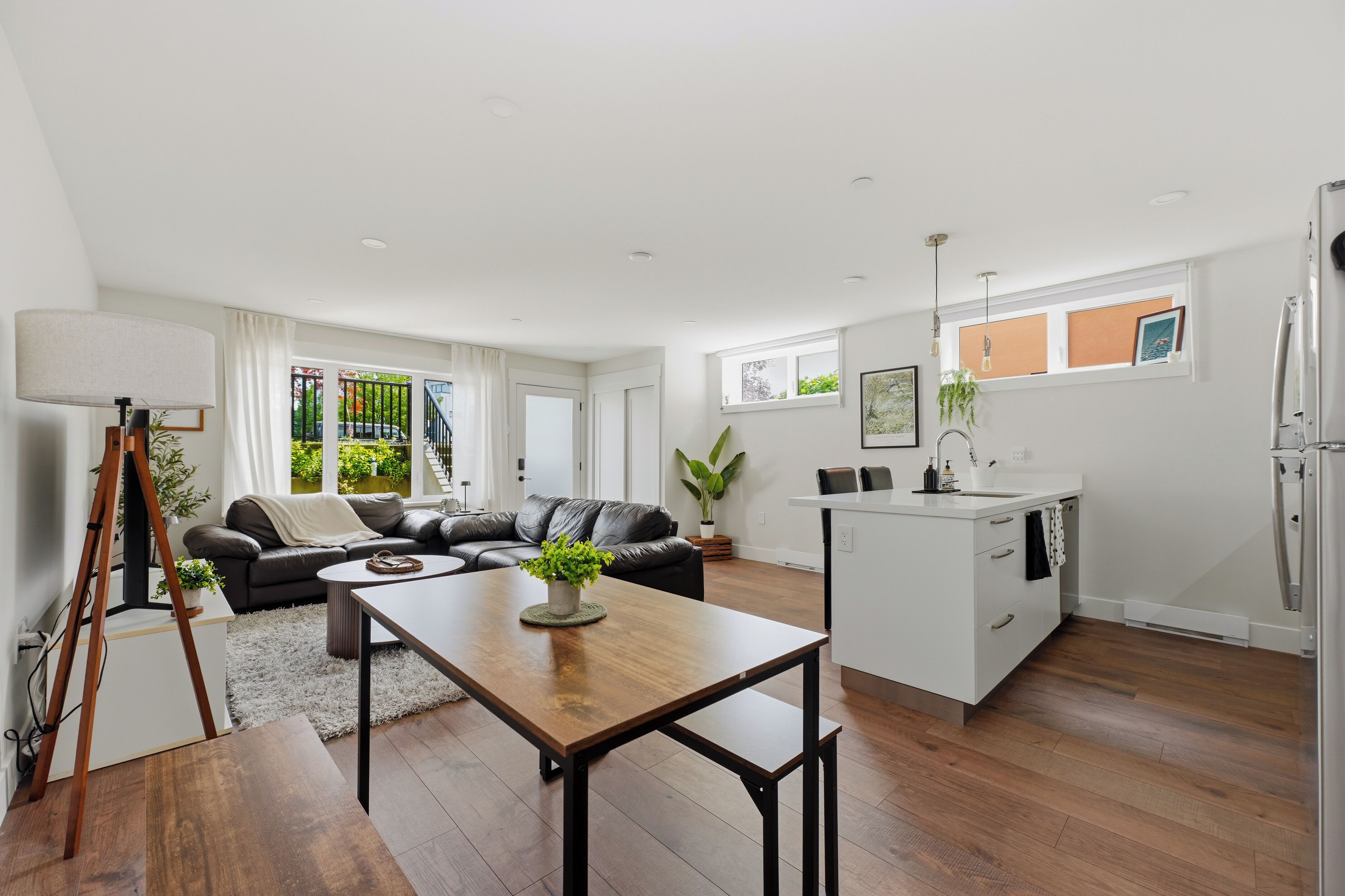 A modern interior with a dining area, kitchen, and living space.