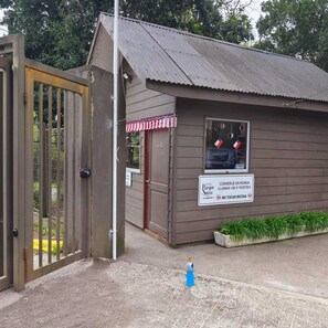 A small building with a corrugated metal roof, a red and white awning, and a sign indicating it is a park and picnic area. - Relax in Pucón (Araucanía)