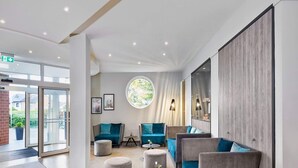A modern lobby with seating, a large window, and a door leading outside. - 1 Person Holiday Park Home in Hurth (Huerth)