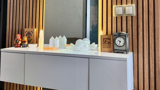 A vanity with a mirror, wooden paneling, and a clock. - Modern Apartment with Wi-Fi and Air Conditioning, Near the Beach and the Medina (Tanger)