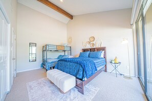 A bedroom with a bunk bed, a single bed, a bedside table, a lamp, and a window. - Lake Conroe Luxury Retreat - Boat Slip & Sunsets (Montgomery)