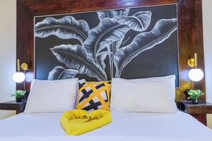 A bed with white bedding, a yellow towel, and a black and yellow pillow. - Beyond Escape-2br-gated-15 Min to Ocho Rios (Boscobel)