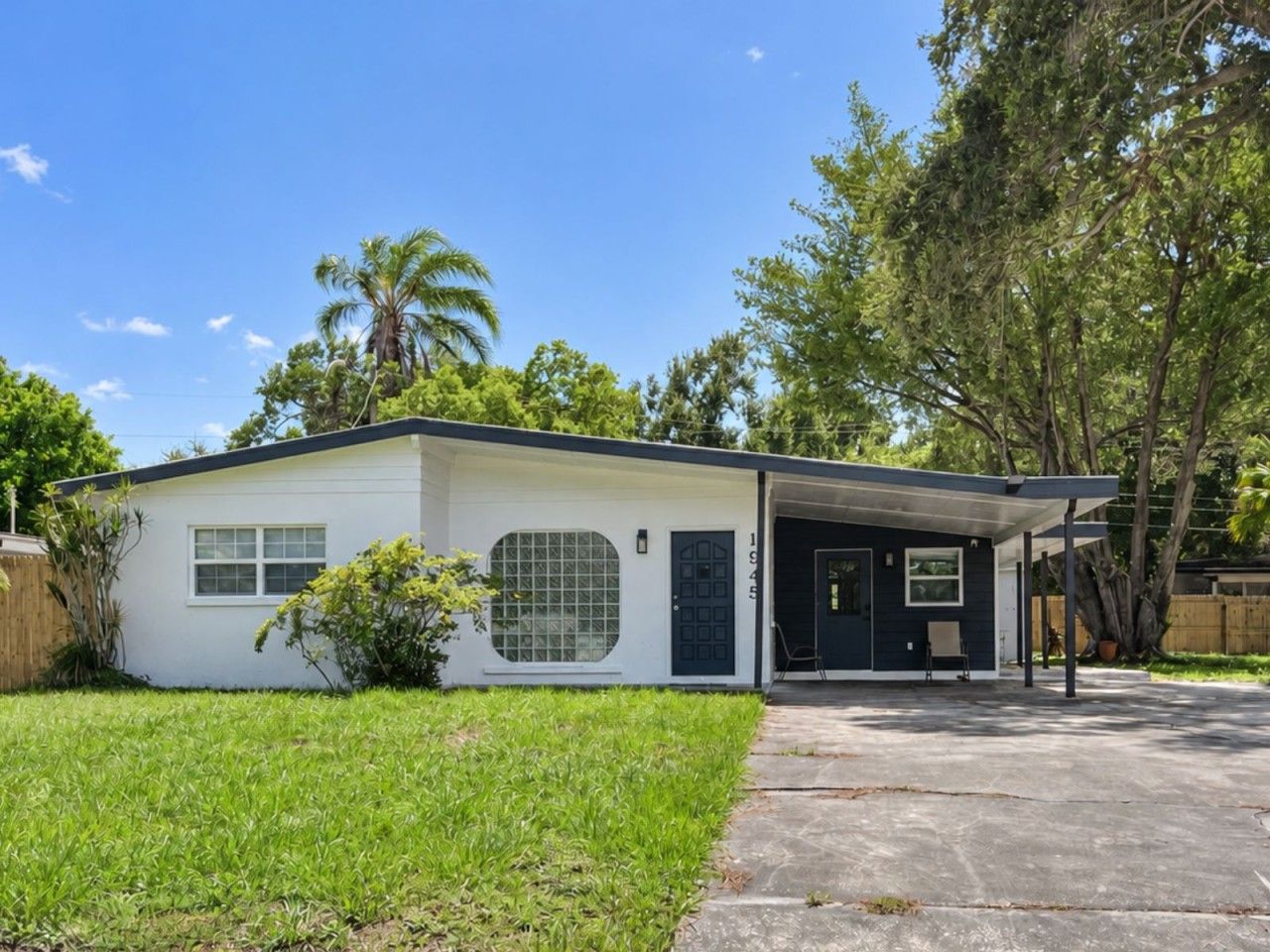 A single-story house with a covered porch, a front door, and a garage.