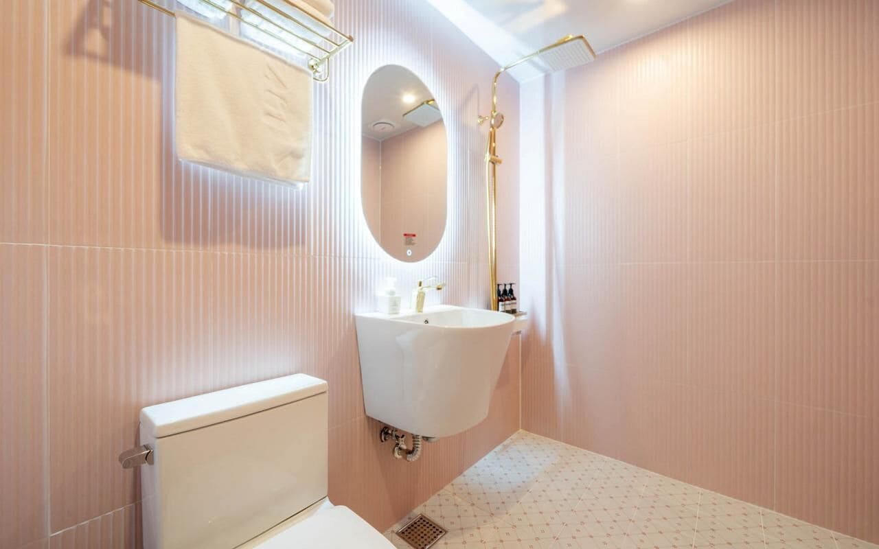 A bathroom with a toilet, a sink, and a shower.