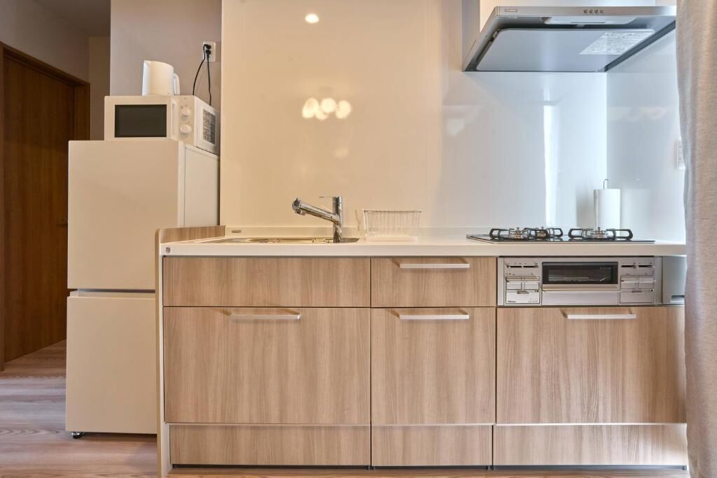 A modern kitchen with a built-in oven, microwave, and dishwasher.
