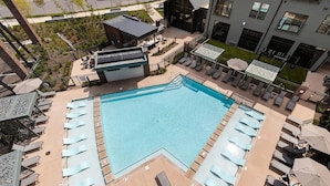 A rooftop pool with sun loungers and a small building with a sloped roof. - Landing | Chic 1BD - One Bedroom Apartment, Sleeps 2 (Nashville)