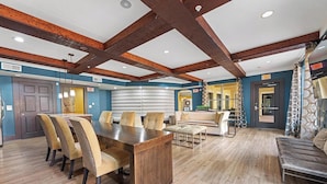 A spacious room with a wooden dining table, comfortable seating, and a cozy seating area. - Landing | Spectacular 1BD, Clubhouse (Irving)
