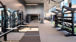 A gym with weightlifting equipment, treadmills, and exercise balls. - Landing | Beautiful 2BD, Yoga Studio, Gym (Denver)