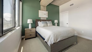 A bedroom with a bed, bedside tables, a window, and a door. - Landing | Beautiful 2BD, Yoga Studio, Gym (Denver)