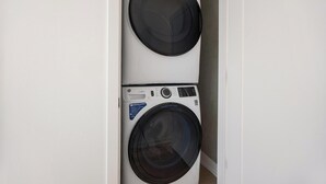 A compact, wall-mounted washer and dryer unit with a control panel and a label indicating 'SMARTER LAUNDRY' and 'ULTRAFRESH VENT SYSTEM'. - Landing | Incredible 1BD, Yoga Studio, Clubhouse (Denver)
