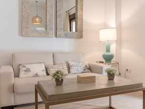A living room with a sofa, two side tables, a coffee table, and a lamp. - Hommyhome San Esteban 101 (Sevilla)