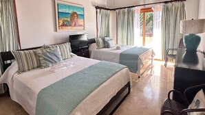 A hotel room with two beds, a ceiling fan, a painting, and a desk with a lamp. - Villa With Private Pool and sea View in Samaná (Samaná)