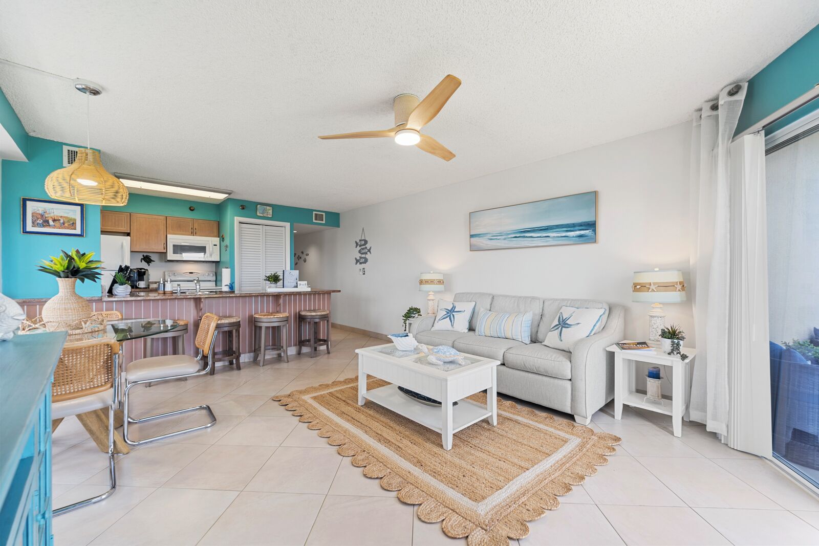 A modern living room with a sofa, coffee table, and a dining area with chairs.