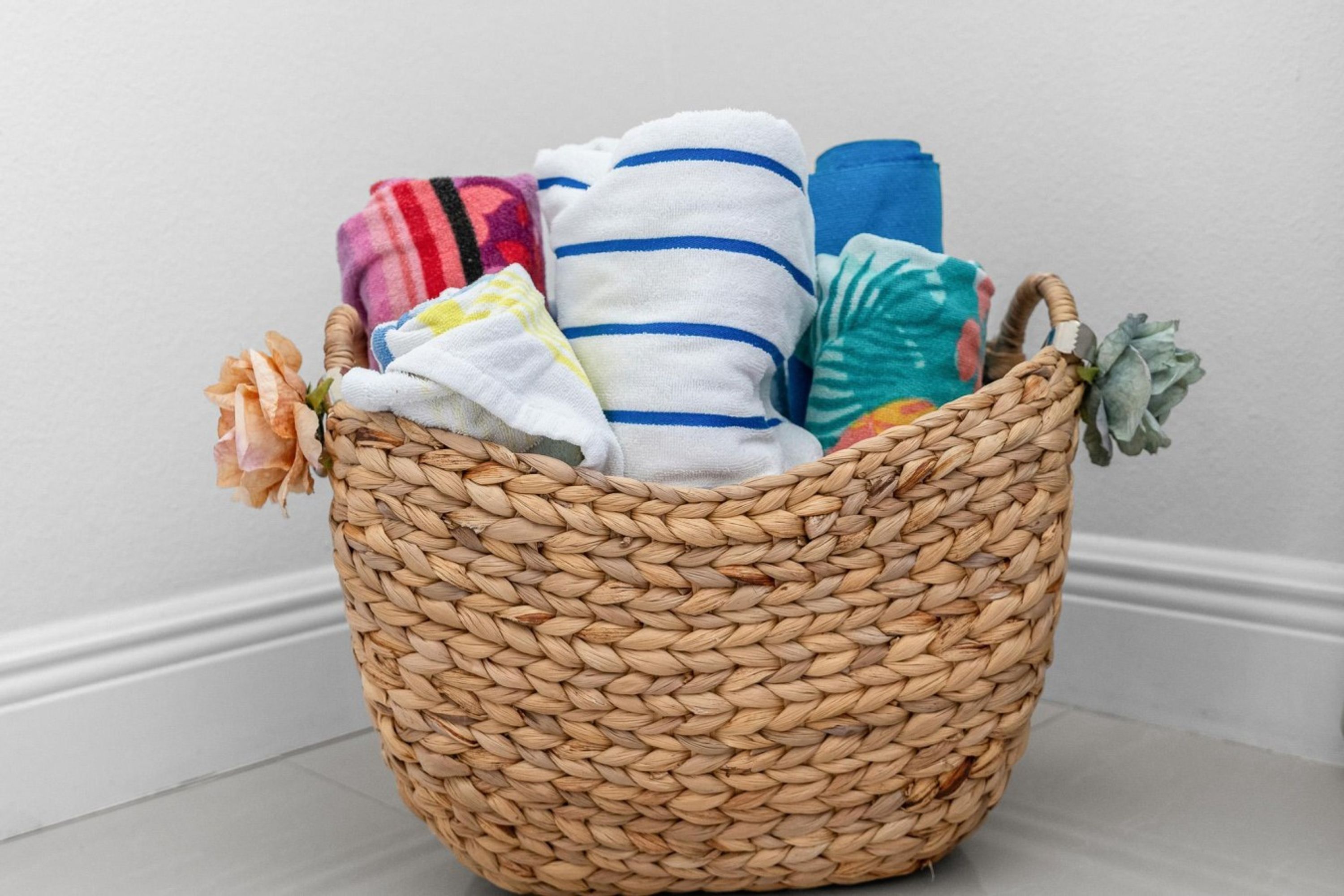 A woven basket filled with folded towels.