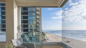 A balcony with a view of a beach and ocean. - Sea Below, Sun Above by Aryve (Main Beach)