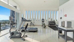 Ein modernes Fitnessstudio mit Trainingsgeräten, Laufband, Ergometer und Rudergerät.
