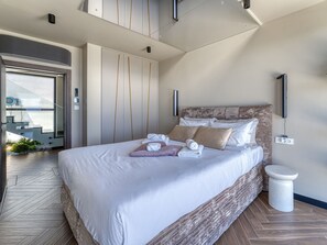 A modern hotel room with a large bed, a built-in wardrobe, a small bathroom, and a view of the outside. - Black Imperium by Interhome (Mošćenička Draga/Sv. Jelena)