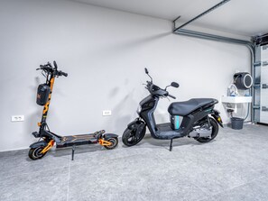 Two scooters parked indoors with a tiled floor and a white wall. - Black Imperium by Interhome (Mošćenička Draga/Sv. Jelena)