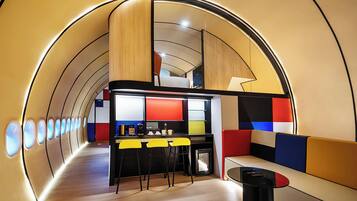 A modern interior with a curved ceiling, a bar area, and seating.