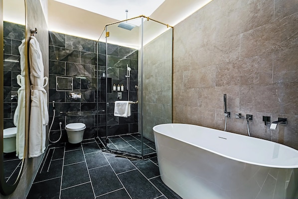 A modern bathroom with a freestanding bathtub, a glass-enclosed shower, and a toilet. - 1975 Avenue & Hotel (Johor Bahru)