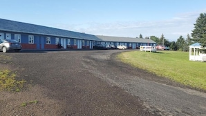 A motel with a long row of rooms, a gravel driveway, and a small gazebo in the yard. - Countryview Motel and Restaurant  (Steeves Mountain)