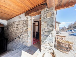 A stone building with a wooden staircase leading to an interior room. - Les Combes 6 by Interhome (Introd)