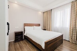 Ein Schlafzimmer mit einem hölzernen Bett, einem Nachttisch und einer Wandleuchte.